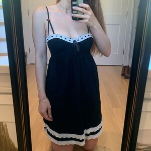 Black mini dress eyelet details with bows and zipper up back white trim